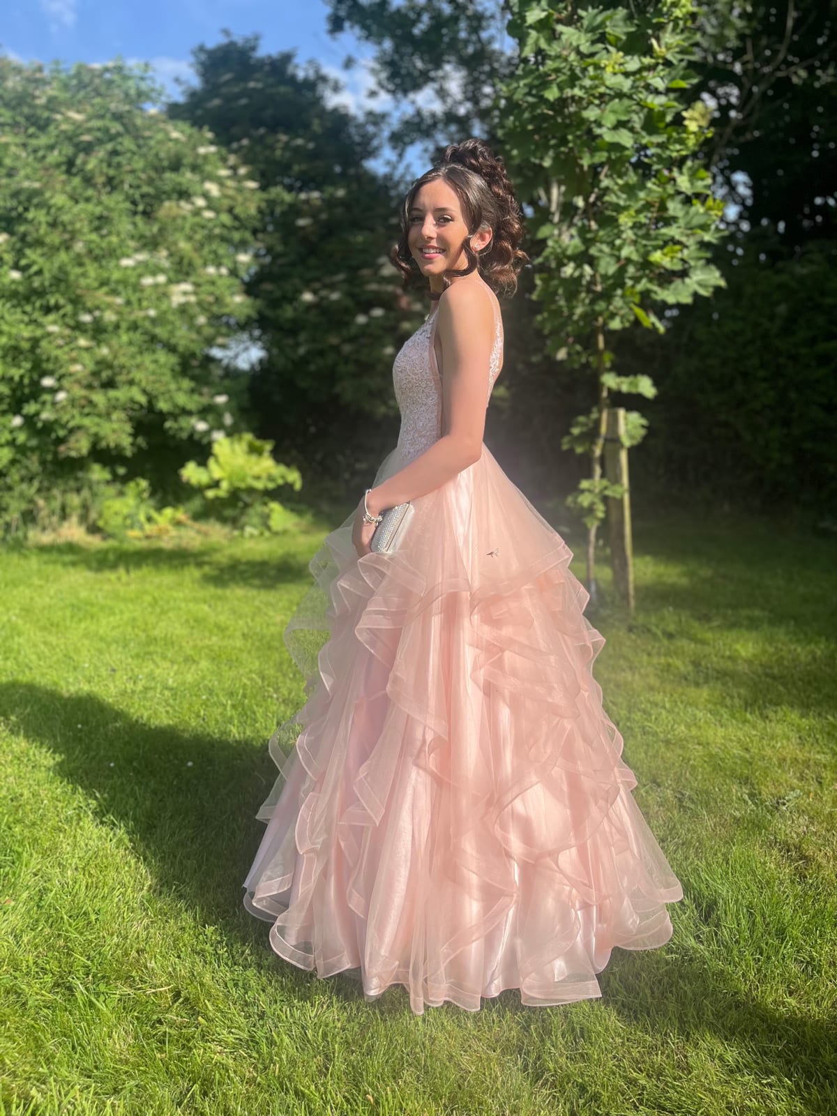 A Maid To Fit customer in a blush pink layered prom dress