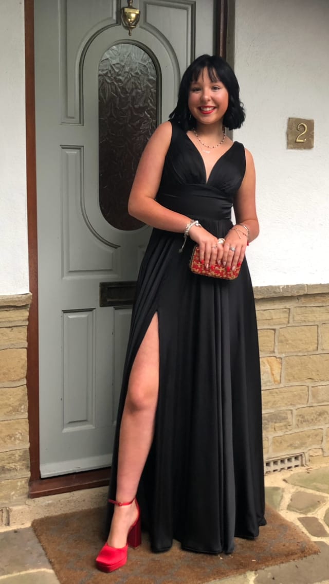 A customer in a flowing black evening dress