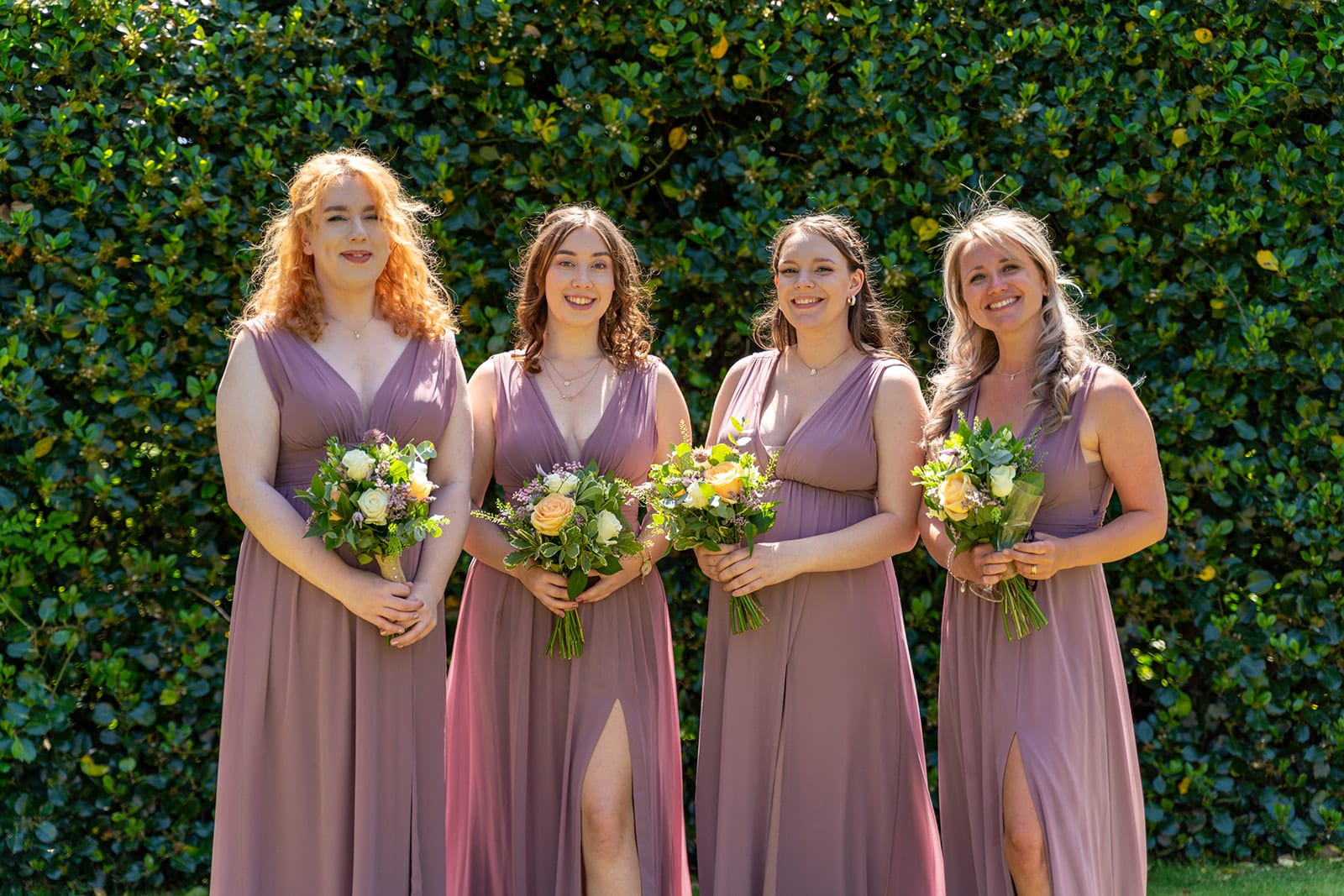 Four bridesmaids wearing lilac dresses, photographed by Olivia Carlisle