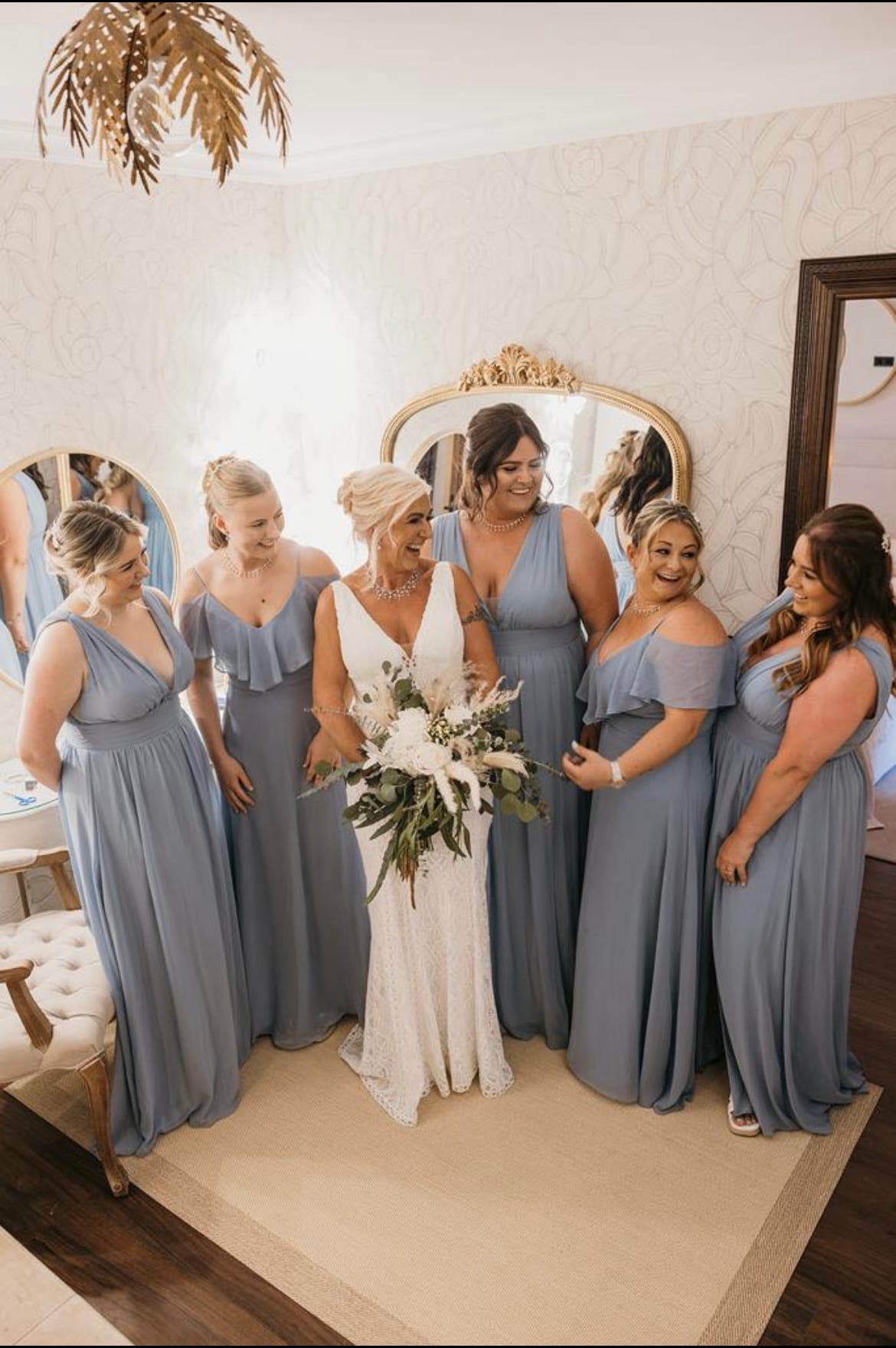 A wedding party with blue bridesmaid dresses